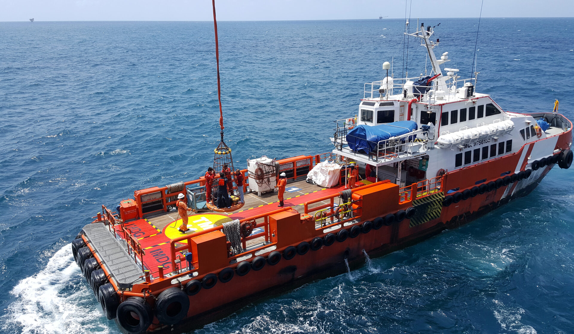 Orange supply vessel on the open sea.